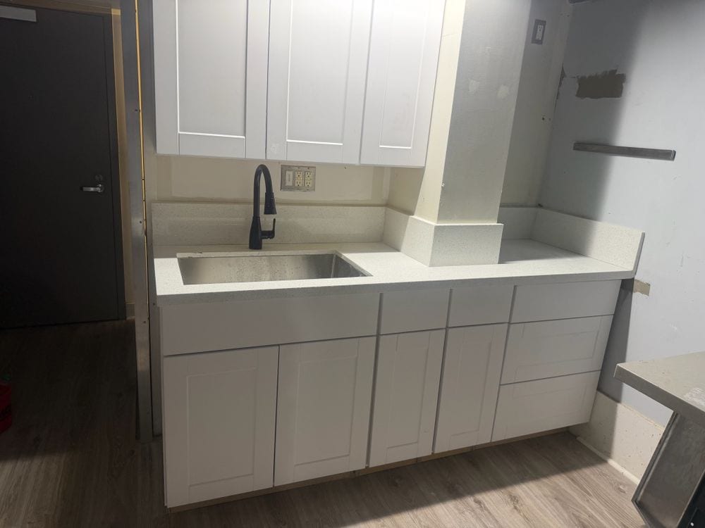 Completed kitchen cabinetry, countertop and sink by IronNest Construction