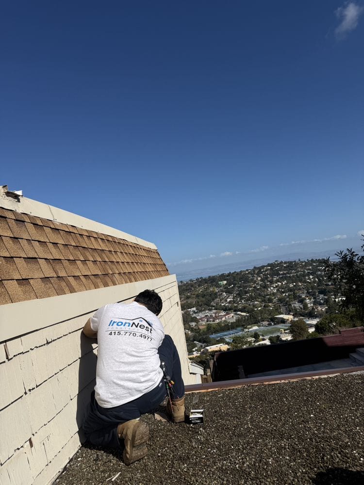 IronNest roofer working on a hillside roof above the Bay in San Francisco